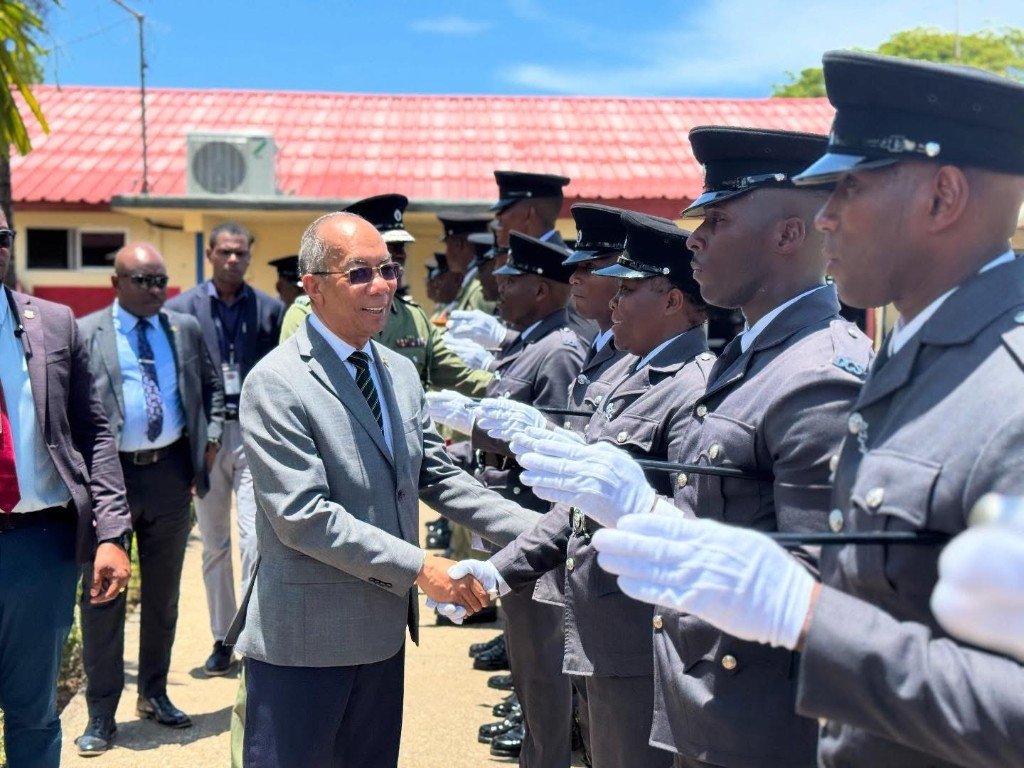 State Minister greeting uniformed correctional officers